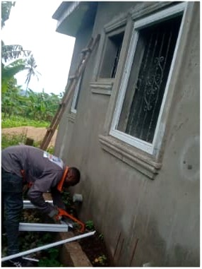 NNANG Group technician cutting an aluminium section on site