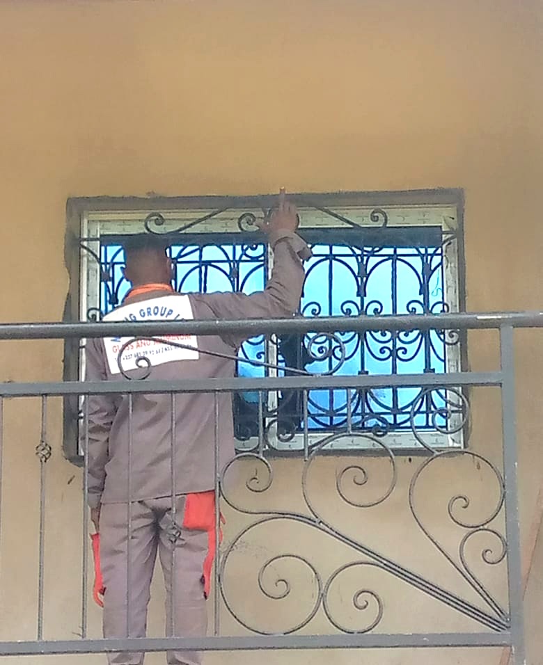 NNANG Group technician fitting an aluminium window on a balcony